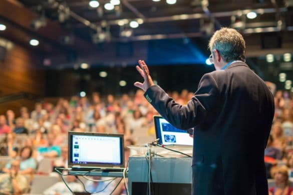 a business executive giving a presentation at a corporate conference